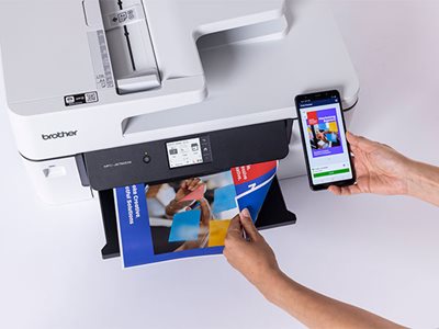 Overhead view of a person using Brother’s Mobile Connect app to print a colour document