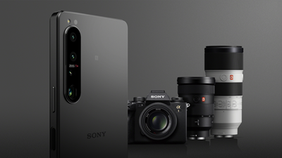 Xperia 1 IV smartphone with Sony Alpha camera and lenses in the background