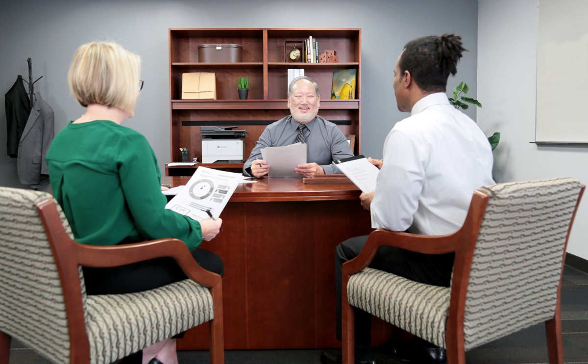 MX331adn three people discussing paperwork