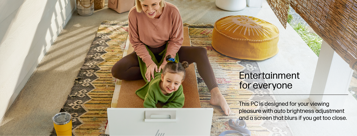 A young woman is seated in front of an HP 23.8" All-in-One Desktop PC.