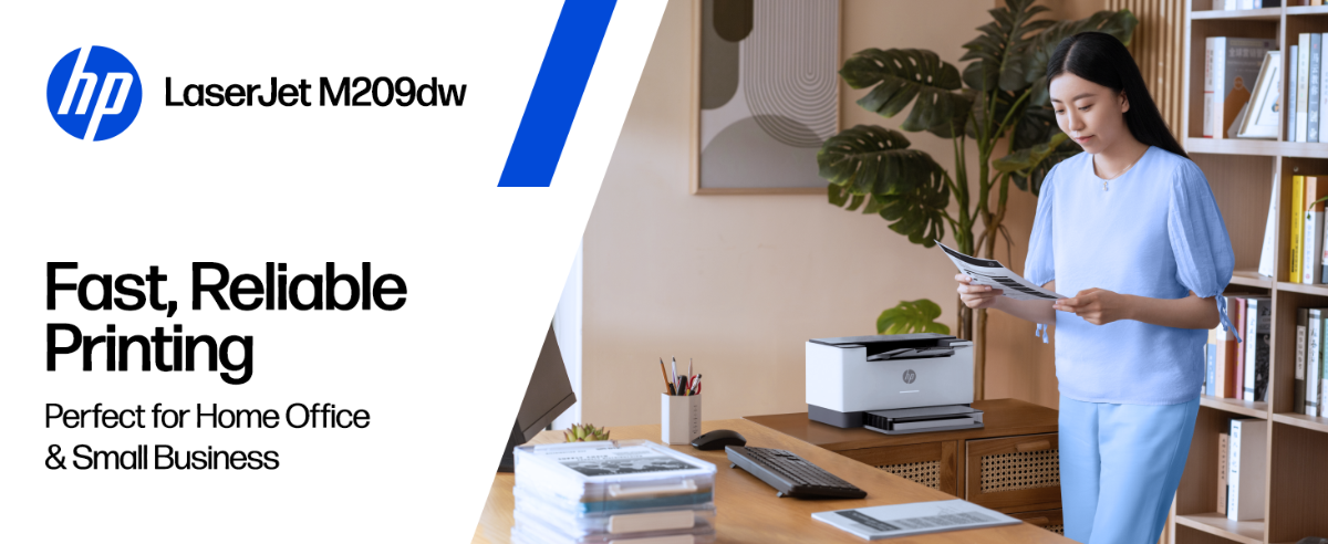 A person holding a document next to an HP LaserJet M209dw printer in a home office.