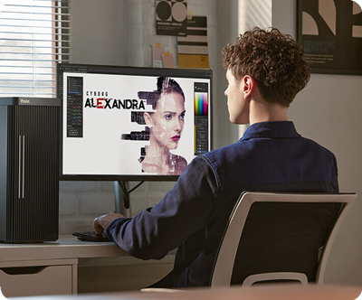 A person in a blue shirt sits at a desk using a ProArt monitor with a digital art program open, featuring a futuristic portrait labeled 'Cyborg Alexandra.'