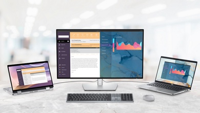 Billede af Dells trådløse tastatur til flere enheder KB700, der er tilsluttet en mus, og en Dell-skærm, bærbar og 2-i-1.