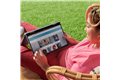 slide 5 of 5, zoom in, young woman uses the hp pavilion convertible laptop while sitting outside.