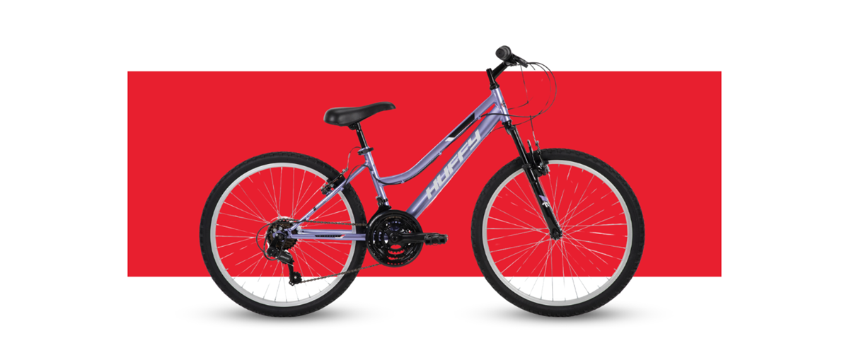 Side profile of the Huffy Rock Creek mountain bike on a red background showcasing the features of the bike.