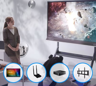a teacher stands by while a video of the solar system plays for the classroom