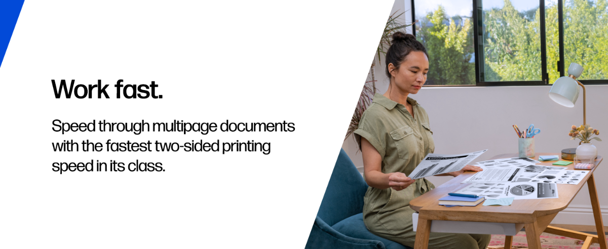 A person reviewing printed documents in a home office.